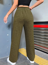 Olive green distressed elastic waist straight leg pants with wide legs and comfortable elastic waistband