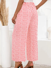 Pink and white polka dot wide leg pants featuring a comfortable flowy design ideal for casual and semi-formal wear