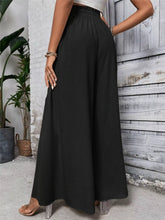 Black high-waisted frill wide leg pants with an elastic waistband designed for comfort and style
