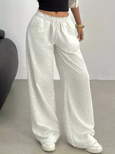 White wide leg drawstring sweatpants featuring loose fit elastic waistband and care instructions for comfort and style