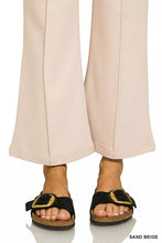 Black suede birkenstock sandals with gold-tone buckle and cork sole styled with heavy ponte elastic waistband pintuck pants