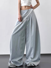Light blue satin wide leg pants with delicate white lace trim and single button closure for elegant wear