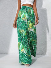 Printed high waist wide leg pants featuring green tropical leaf print in lightweight breathable fabric