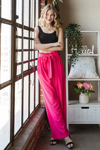 Heimish plus size bright pink tie pants with flowing wide legs and a paperbag waistband offer comfortable style