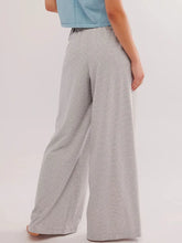 Drawstring striped wide leg pants in soft gray and white stripes made from comfortable stretchy fabric