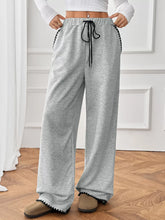 Gray heathered wide-leg pants with black drawstring waistband and scalloped edge detailing machine wash care instructions