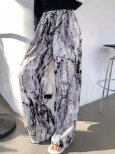 Black and white marble patterned abstract print wide leg pants featuring a comfortable loose fit for stylish wear