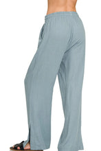 Light blue zenana linen drawstring pants with elastic waistband and side slits in loose-fitting wide-leg style