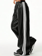 Black satin wide-leg pants with three bold white stripes down the side designed as striped wide-leg pants tumble dry safe