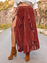 Plus size velvet ruffle hem wide leg pants in rust with layered ruffles and a high slit in flowing velvet fabric