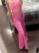 A vibrant pink sequin embellished wide leg pants paired with a floral crop top in a mermaid-style two-piece set