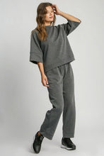 Gray heathered sweatshirt with relaxed fit and three-quarter sleeves paired with umgee full size drawstring wide leg pants with pockets
