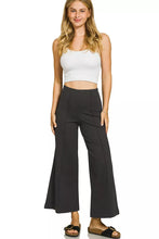 Black heavy ponte pintuck pants with elastic waistband featuring high-waisted wide-leg tailored fit and side pockets