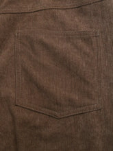 Brown corduroy wide leg casual pants featuring textured ribbed fabric and a matching stitched pocket detail