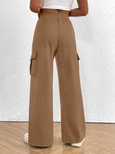 Tan casual high waist cargo pants with wide legs elastic waistband and side pockets for comfortable wear