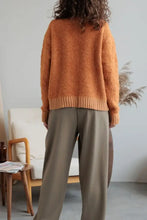 Orange fuzzy long sleeve cardigan with collared neck button front