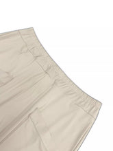 Plus size relaxed fit beige cargo pants with elastic waistband and visible stitching for casual wear