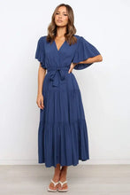 Navy blue tiered wrap dress with flutter sleeves and tie waist