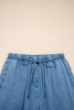 Light-wash chambray pants with ruffled hem wide leg design elastic waistband and matching drawstring closure