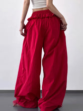 Red ruffled wide leg pants made of smooth shiny fabric with drawstring for comfortable fit and stylish look