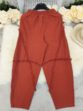 Crimped orange cotton frayed edge harem pants with diagonal frayed trim showcasing unique edge harem pants design