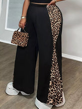 Plus size leopard print wide leg pants in black with bold leopard print side panels for stylish comfort