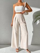 Cream-colored wide leg high waist trousers with a sleek tailored fit perfect for formal and casual occasions
