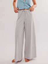 Gray and white drawstring striped wide leg pants featuring a comfortable waistband and relaxed fit design