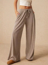 Beige corduroy drawstring wide leg pants featuring a comfortable waistband and relaxed fit design