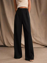 Black high-waisted wide-leg pants with tailored pleats and a structured fit for a polished look