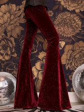 Deep red velvet high waist flared pants with a subtle glittery texture perfect for elegant occasions