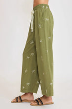 Olive green plus size wide leg pants with lace drawstring waistband and white embroidered bows by umgee