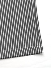 Black and white vertically striped wide leg drawstring pants with a neat hem for comfortable casual wear