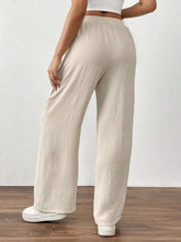 Beige casual drawstring wide leg pants with relaxed textured fabric and elastic waistband for comfortable wear