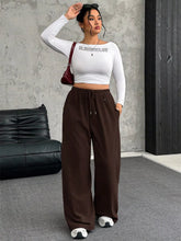White long-sleeved crop top paired with full size drawstring wide leg pants in plus size for comfortable style