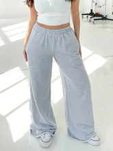 Light gray loose-fitting sweatpants with elastic waist wide design and wide leg for comfortable casual wear