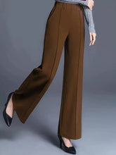 Brown high-waisted wide leg pants with a sleek tailored fit made from durable fabric featuring machine wash care instructions