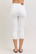 White denim judy blue capri pants with extended waistband and classic back pockets featuring brown leather patch