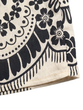 Beige fabric boho print wide leg pants with bold black floral and paisley pattern for stylish comfort