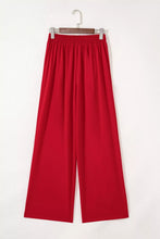 Red wide-leg pleated detail pants with high elastic waist made of smooth flowing fabric for comfortable wear