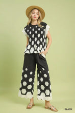 Black and white hexagon print peplum top with ruffled sleeves paired with umgee wide leg pants with scalloped hem