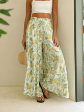 White wide leg drawstring paperbag waist pants with vibrant yellow and green pineapple and leaf print