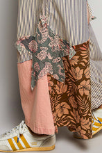 Patchwork star appliqué in muted green and pink floral pattern on wide-leg pants with partial elastic and big star patch