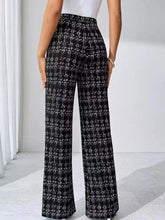 Black and white plaid wide-leg pants in textured tweed fabric featuring a classic plaid pattern and wide-leg design