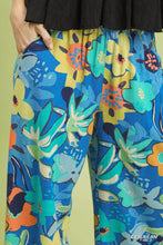 Umgee floral print wide leg pants in vibrant blue with bold yellow teal and orange blossoms on flowing fabric