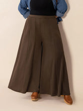 Plus size wide leg pants in olive green high-waisted pleated fabric with pockets for comfortable wear