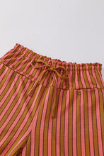Wide leg stripe button pocket tie pants with pink and mustard yellow vertical stripes and a drawstring waistband