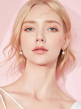 Blonde woman in light top wearing 925 sterling silver freshwater pearl earrings
