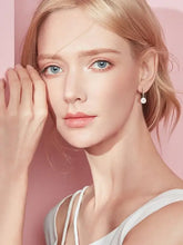 Blonde woman with blue eyes wearing 925 sterling silver freshwater pearl earrings