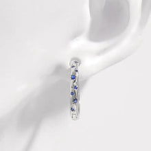 Sterling silver huggie earrings with blue zircon gemstones